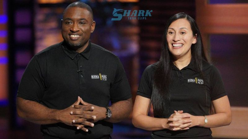 Entrepreneurs James and Johanna Windon smiling confidently while presenting their business on Shark Tank, wearing branded polo shirts on the show's stage