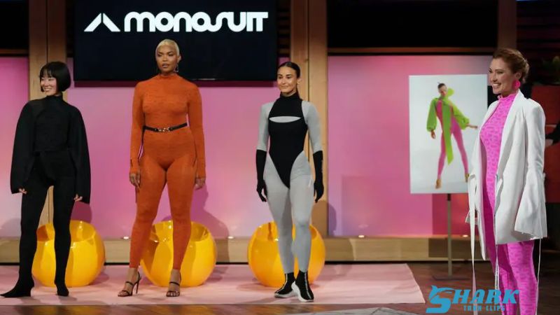 Entrepreneur presenting Monosuit on Shark Tank with models wearing stylish one-piece jumpsuits, against the show's signature stage backdrop