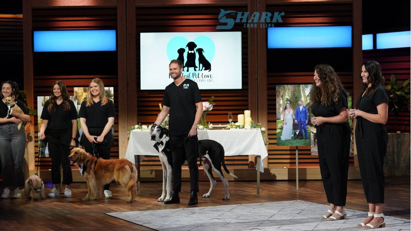 Team from FairyTail Pet Care on Shark Tank with a lineup of happy dogs and their handlers, showcasing the pet-friendly services of their company on stage.